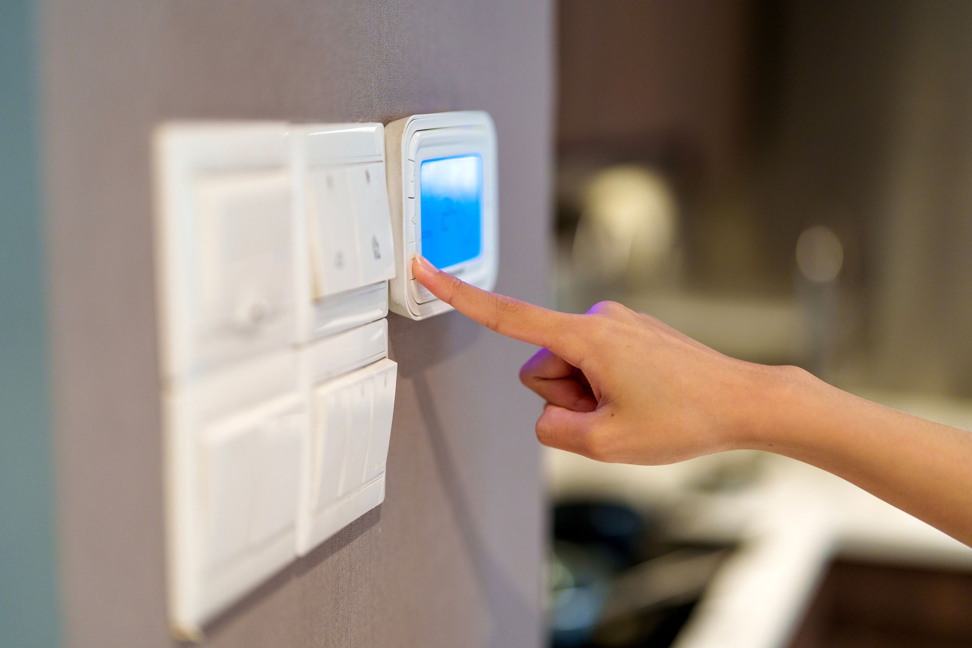 Person Using a Smart Home System Control Panel